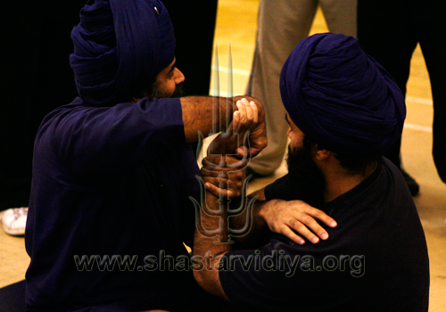 Nidar Singh Nihang engaged in the traditional Punjabi game of Beeni Shadauni (releasing the wrist), London